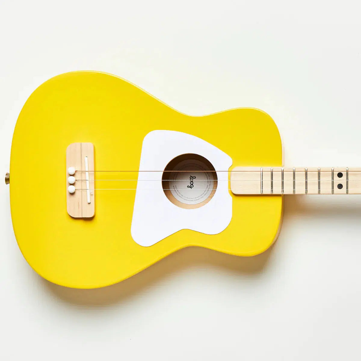 Front view of the yellow acoustic guitar against a white background.