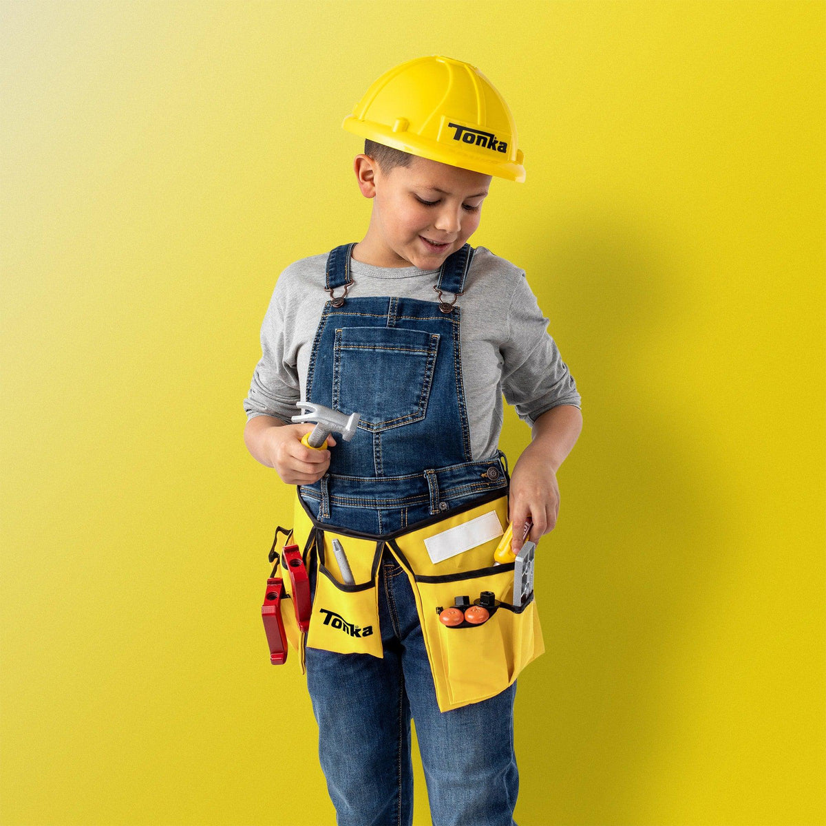 Front view of a young boy wearing the hat and tool belt from the Tonka Tough Tool Belt &amp; Hat Set.