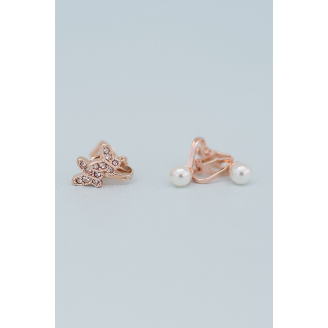 detail of butterfly and pearl earrings