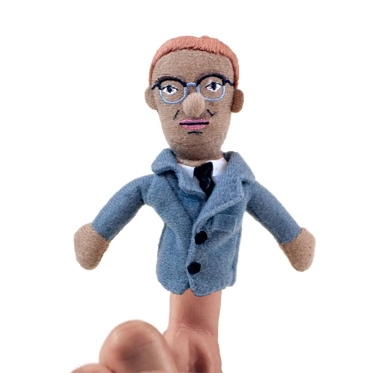 Front view of Malcolm X Magnetic Personality Finger Puppet sitting on a person&#39;s finger.