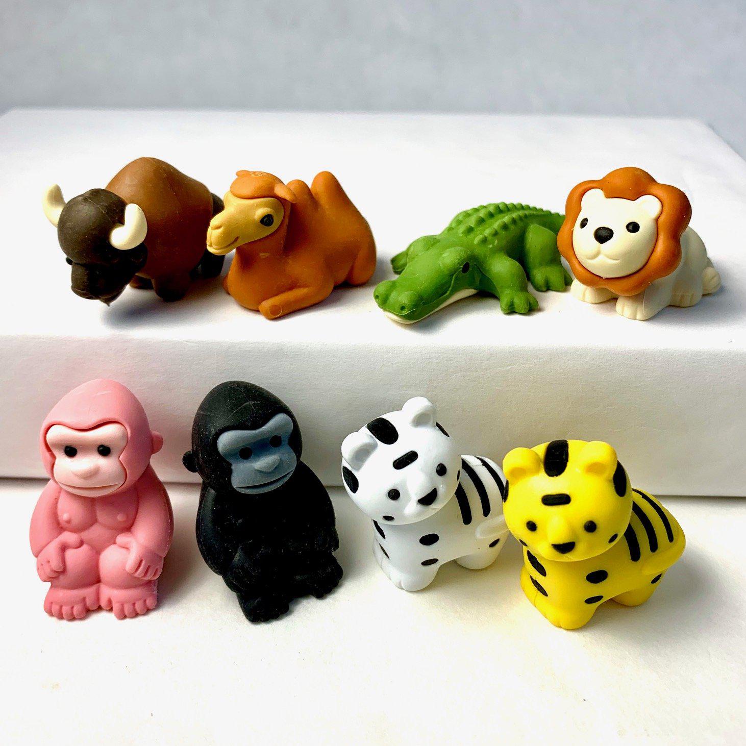 Front view of a variety of Puzzle Eraser-Safari including an alligator, bison, pink and black gorillas, lion, camel, and yellow and white tigers.