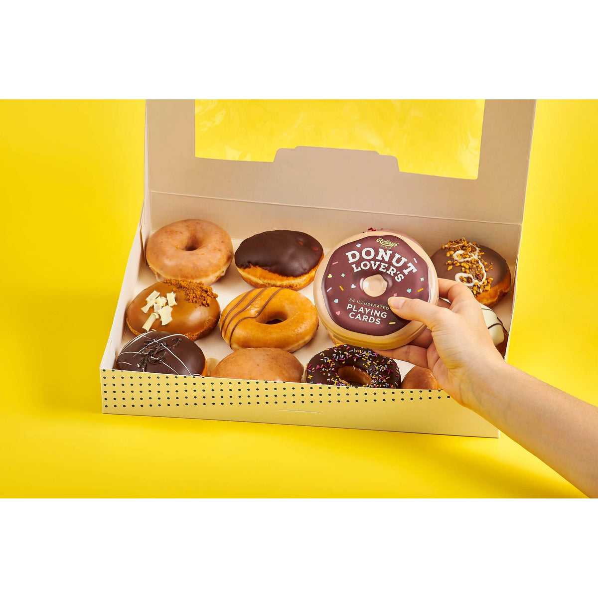 Front view of the Donut Lover&#39;s Playing Cards being held above a box of donuts.