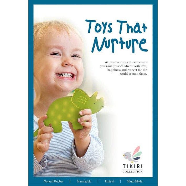 Front view of a poster featuring a baby holding the Natural Organic Rubber - Trice the Baby Triceratops