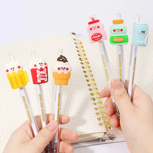 Front up close view of a person's hands holding the assorted styles of the 24-Hour Snack Shop Retractable Pen including the beer, drink, yogurt, ice cream cone, pop corn and cola over a spiral notebook.
