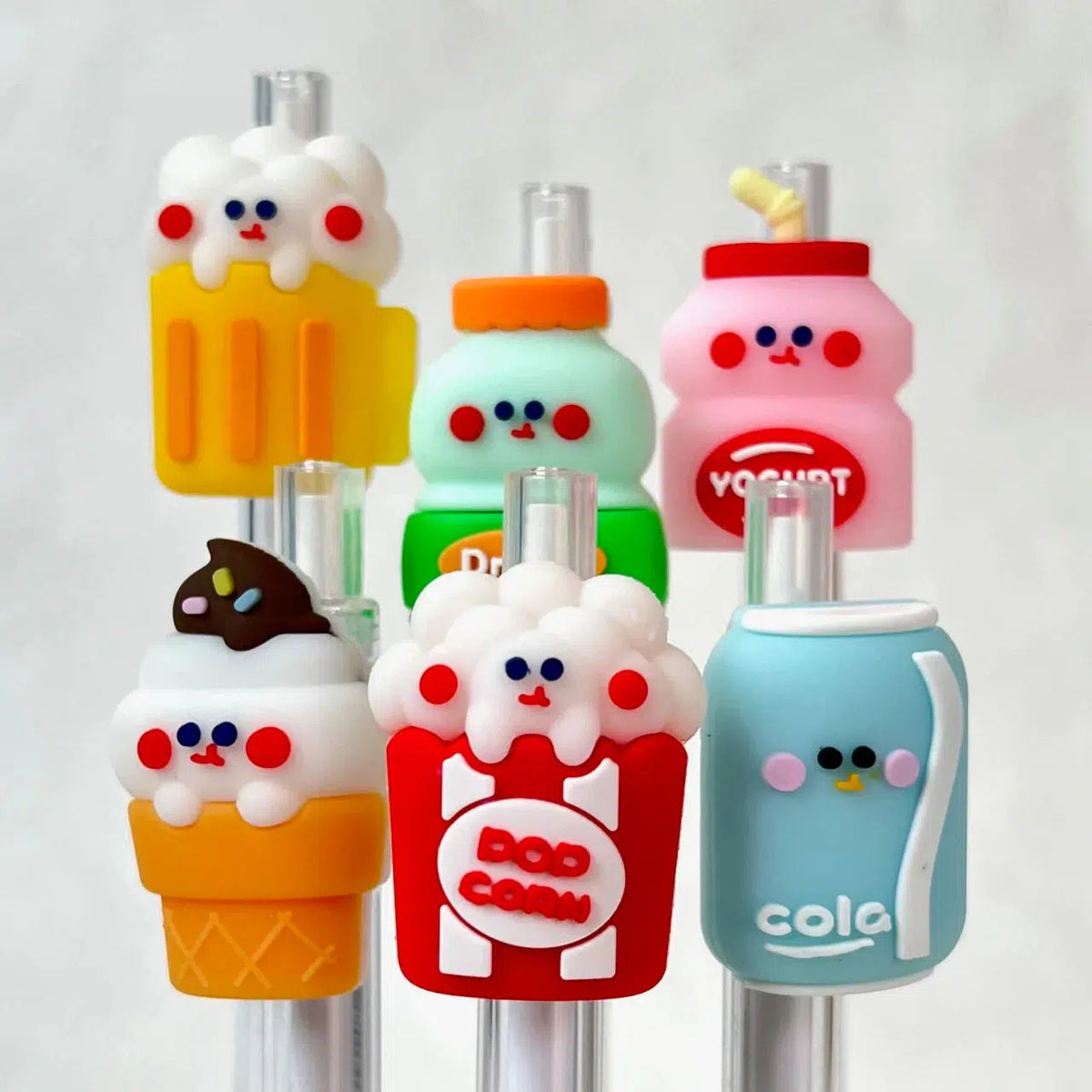 Front view of the assorted styles of the 24-Hour Snack Shop Retractable Pen including the beer, drink, yogurt, ice cream cone, pop corn and cola.