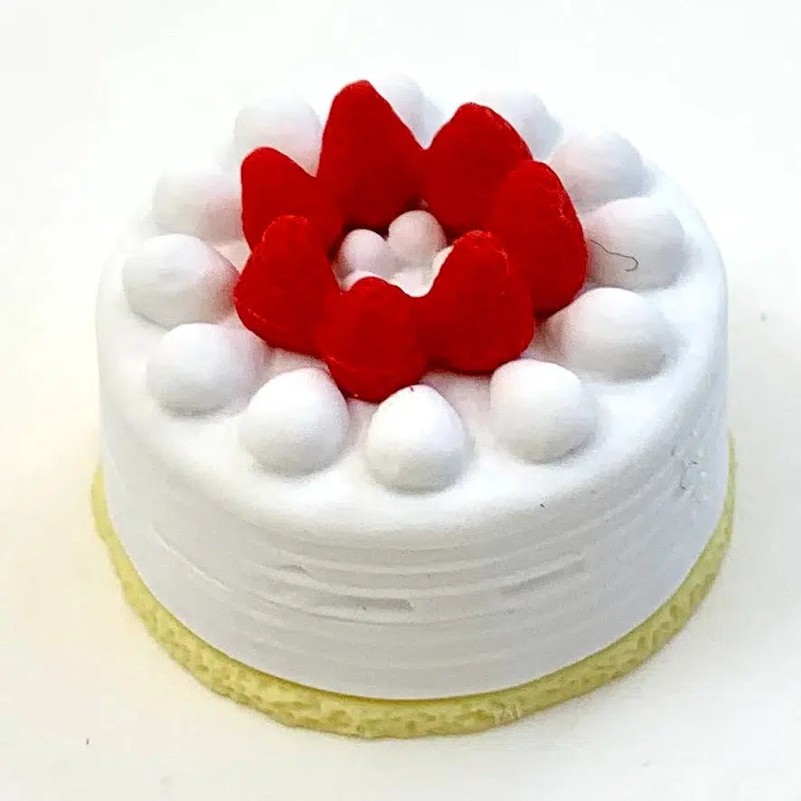 Front view of a cake with white frosting and strawberries on top from the Puzzle Eraser Card Set-Dessert.