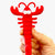 Front view of a person's hand holding a Gel Pen-Lobster. 