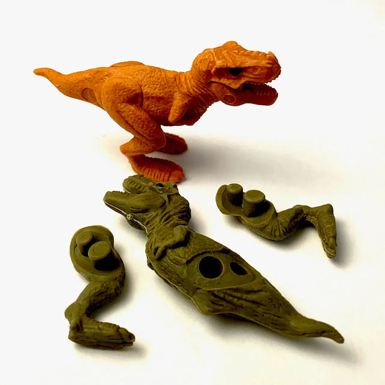 Front view of both orange and green T Rex Dinosaur Eraser.