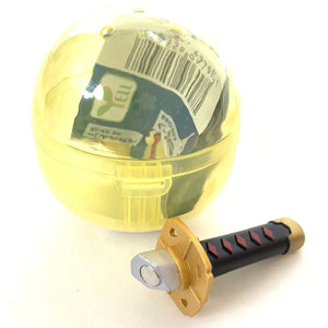 Front view of the yellow Capsule with black and gold sword from the Samurai Katana Sword Magnet Capsule.