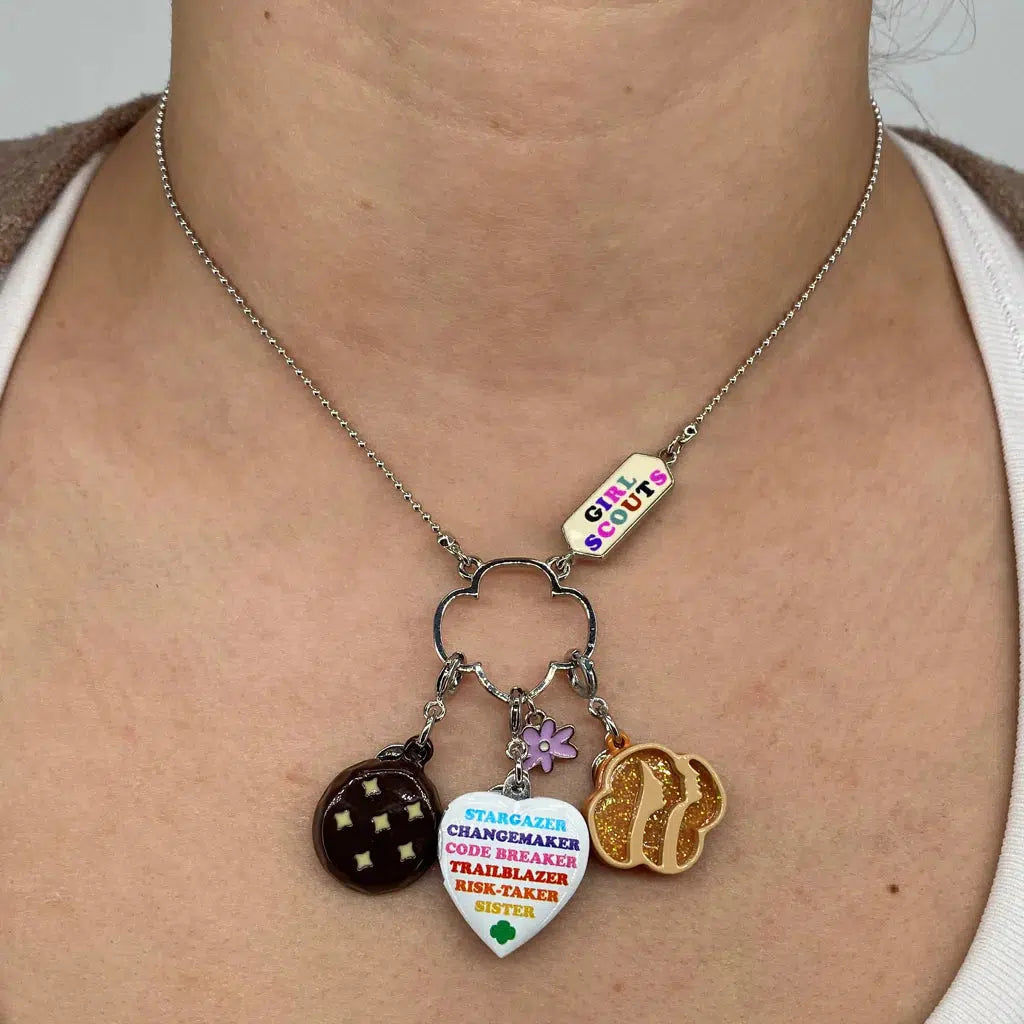 Front view of a person&#39;s neck showing a charm necklace with the Charm It-Girl Scout Thin Mints Charm on it.