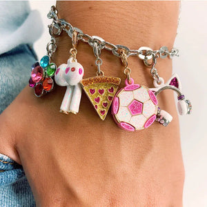 Front up close view of a person wearing a charm bracelet with the Charm It-Glitter Pizza Charm on it.