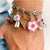 Front up close view of a person wearing a charm bracelet with the Charm It-Glitter Pizza Charm on it.