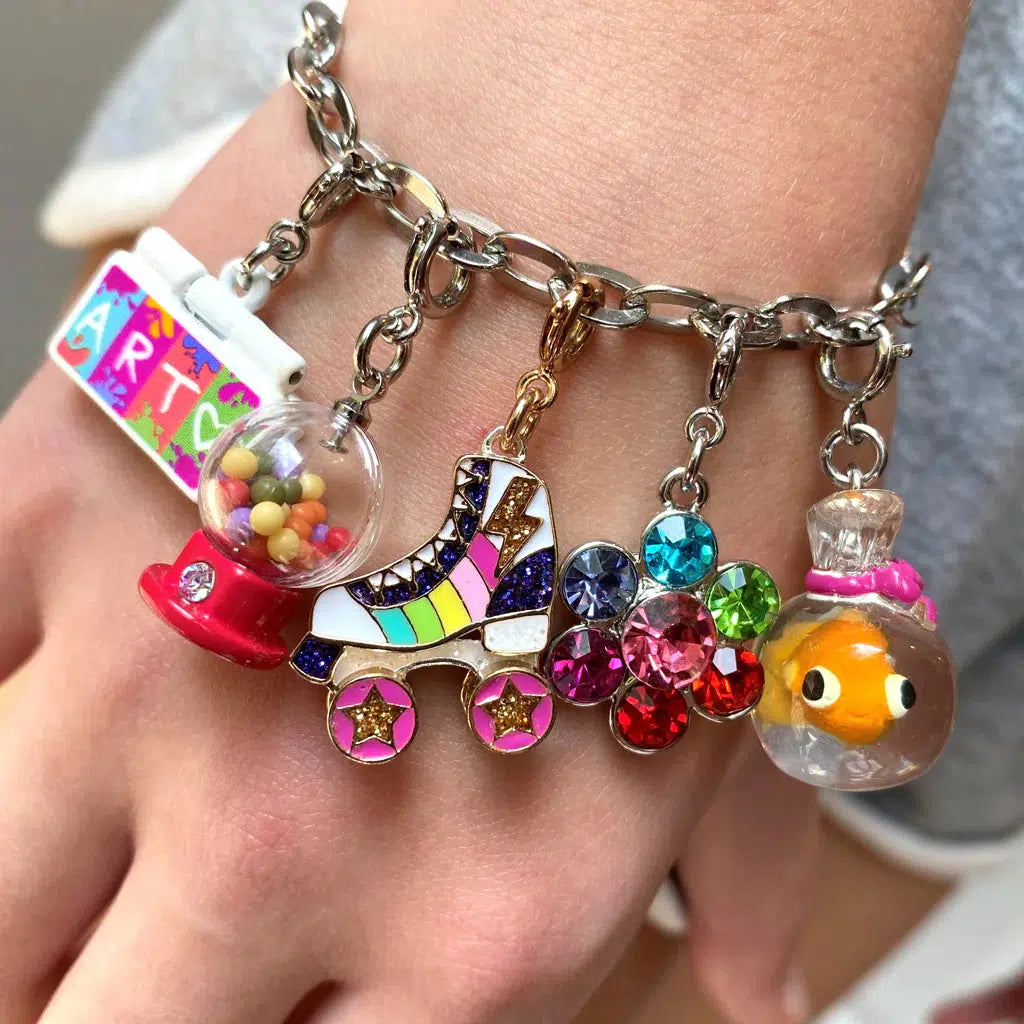 Front up close view of a person wearing a charm bracelet with the Charm It-Gold Rainbow Rollerskate Charm.