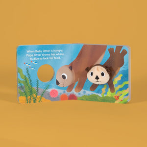Front view of Baby Otter Finger Puppet book inside pages with baby otter diving for food.