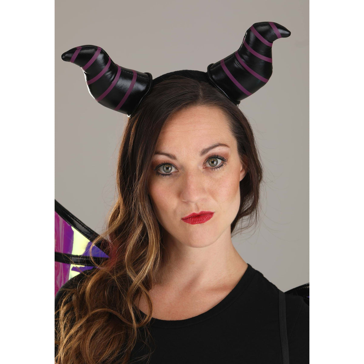 Front up close view of a woman wearing the Maleficent Dragon Horns Headband &amp; Wings.