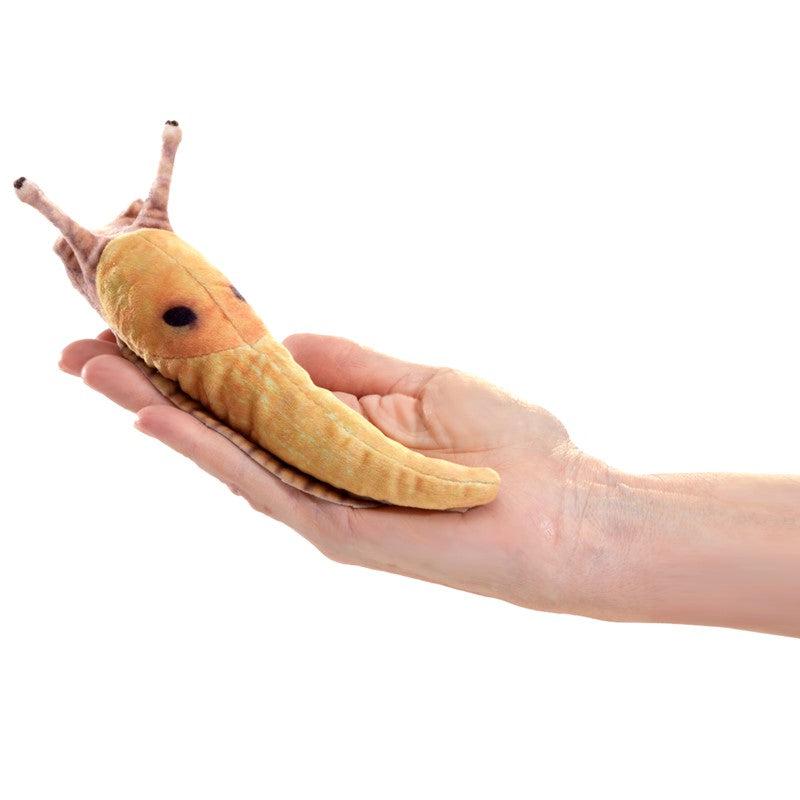 Front view of a person&#39;s hand holding a Mini Slug, Banana-Finger Puppet showing the rear view of the puppet.
