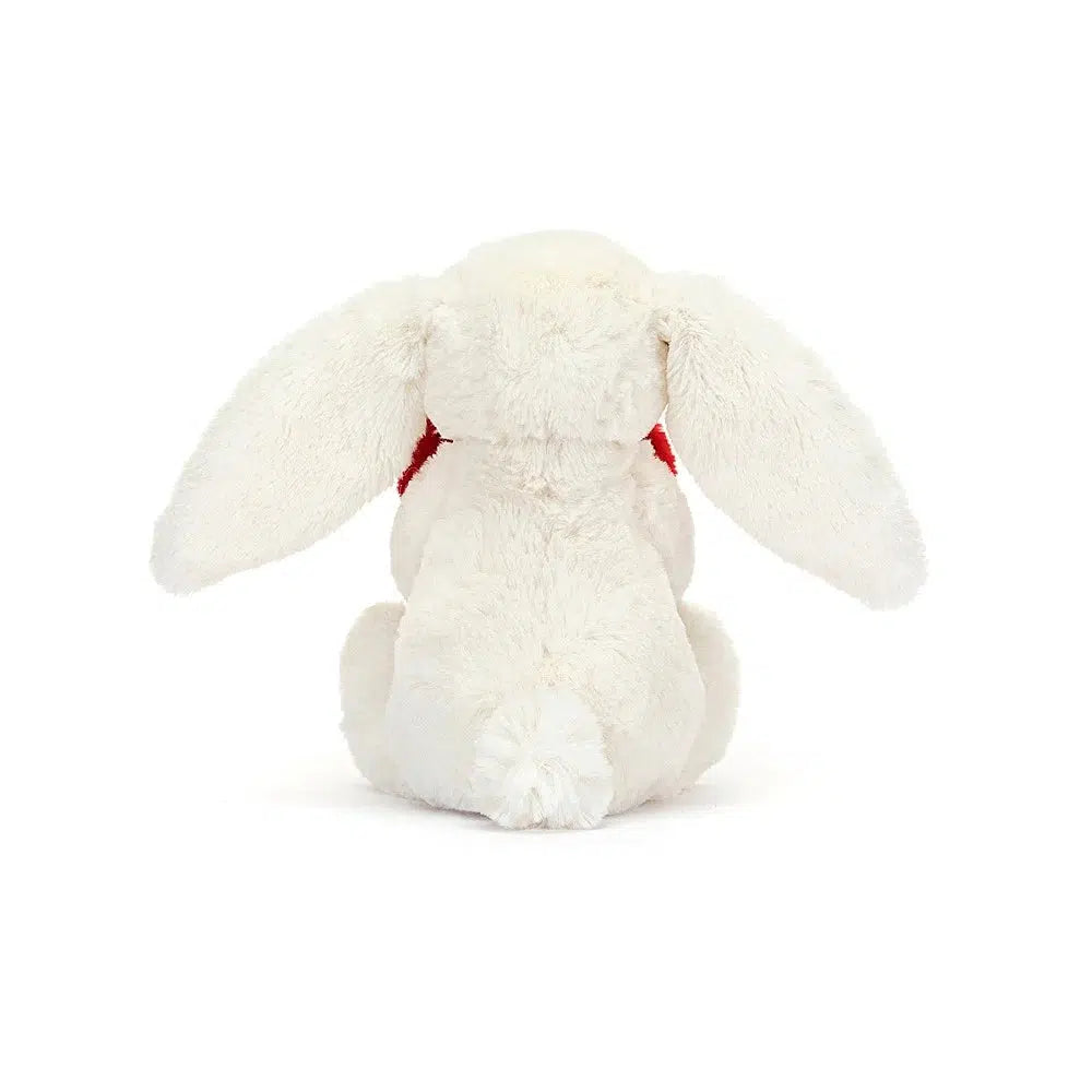 Rear view of Jellycat Bashful Little Heart Bunny holding the red heart.
