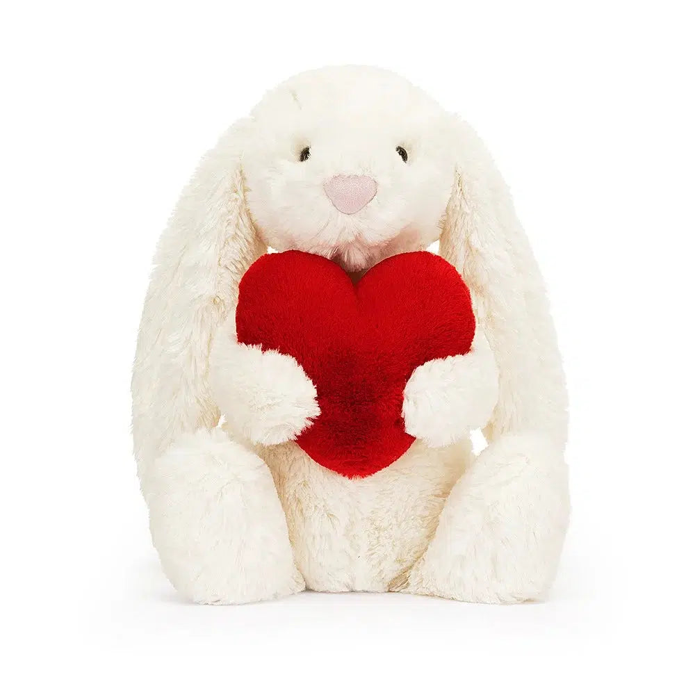 Front view of Jellycat Bashful Little heart bunny holding the red heart.