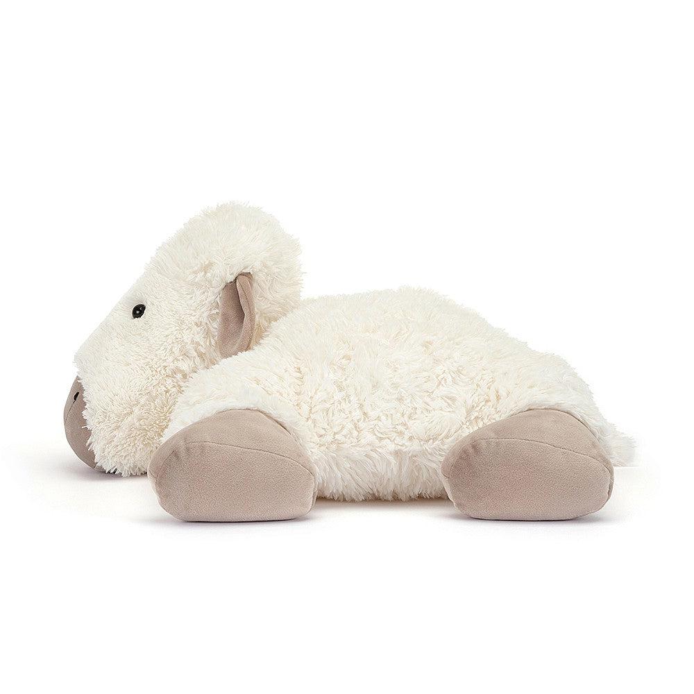 Front side view of Truffles Sheep-Large laying with arms and legs out to the side.