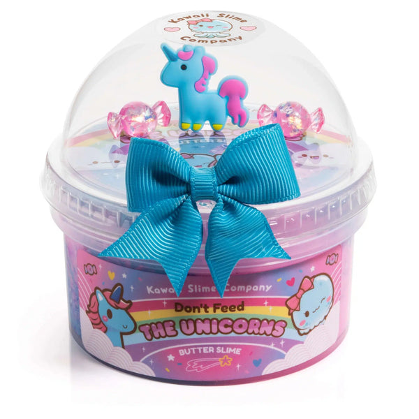Front view of Don't Feed The Unicorns Butter Slime in its container.