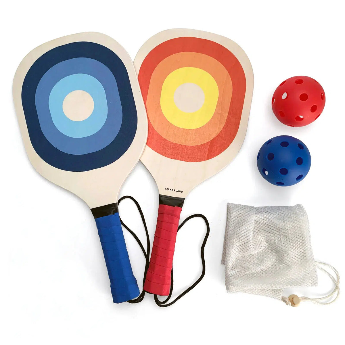 Front view of the contents of Pickleball laid out including the 2 paddles, 2 balls, and mesh bag.