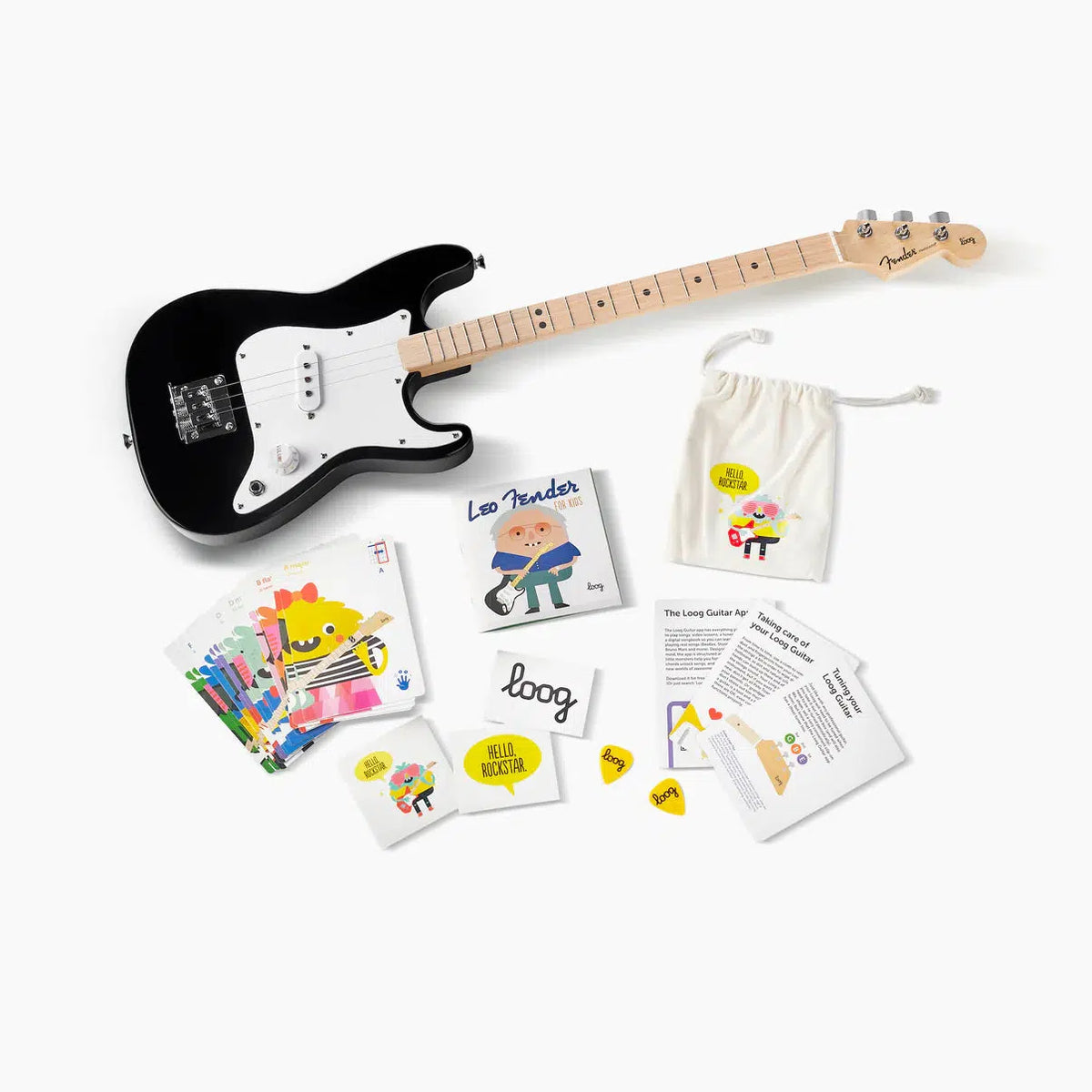 Front view of the Fender X Loog guitar and everything included in the box with it against a white background.