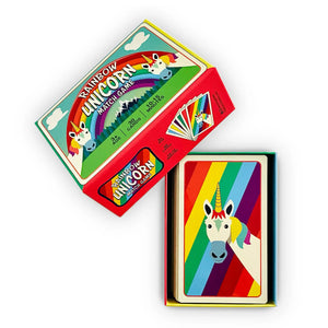 Front view of the rainbow unicorn game in the box. The top of the box is taken off and leaning against the bottom of the box.