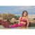 Front view of a young woman sitting in the water wearing the Fiji Red Mermaid Tail + Monofin Set.