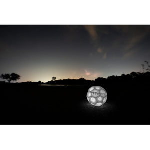 Front view of a lit up Moonshine Ball with an outdoor nighttime background.