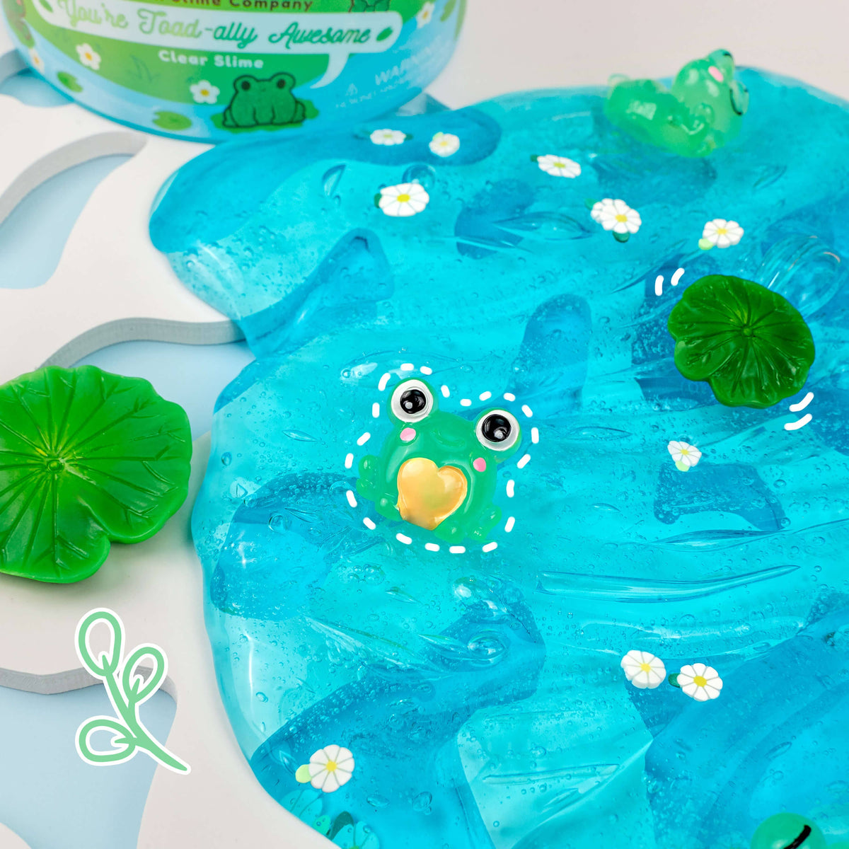 Front view of You&#39;re Toad-ally Awesome Slime out of container with decorations.