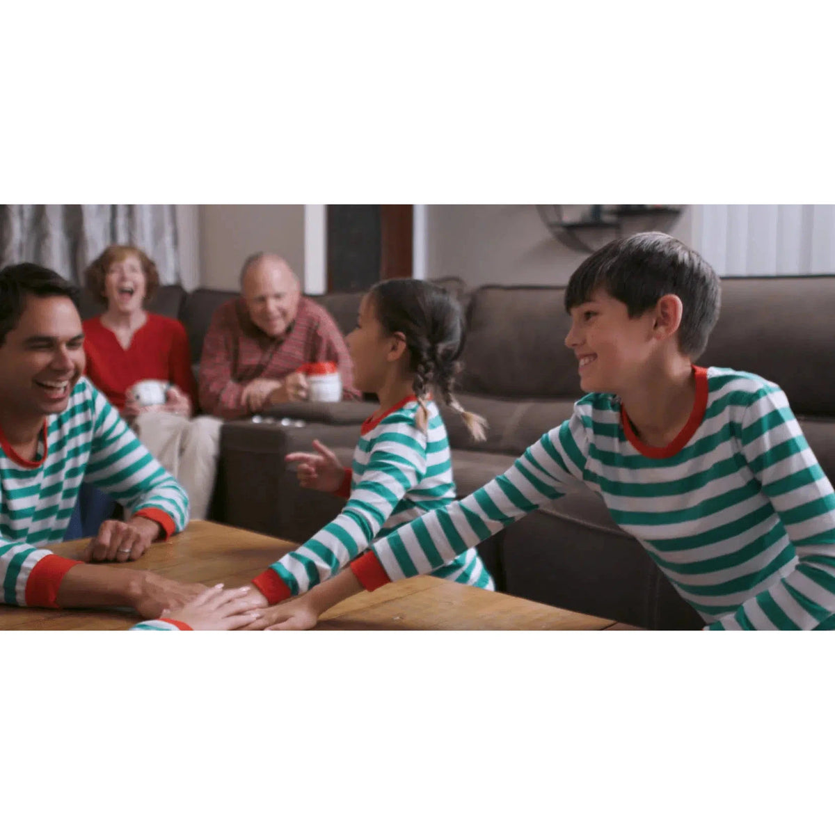 Front view of a family with children and grandparents all enjoying the game.