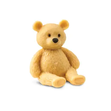 Tiny realistic teddy bear sitting