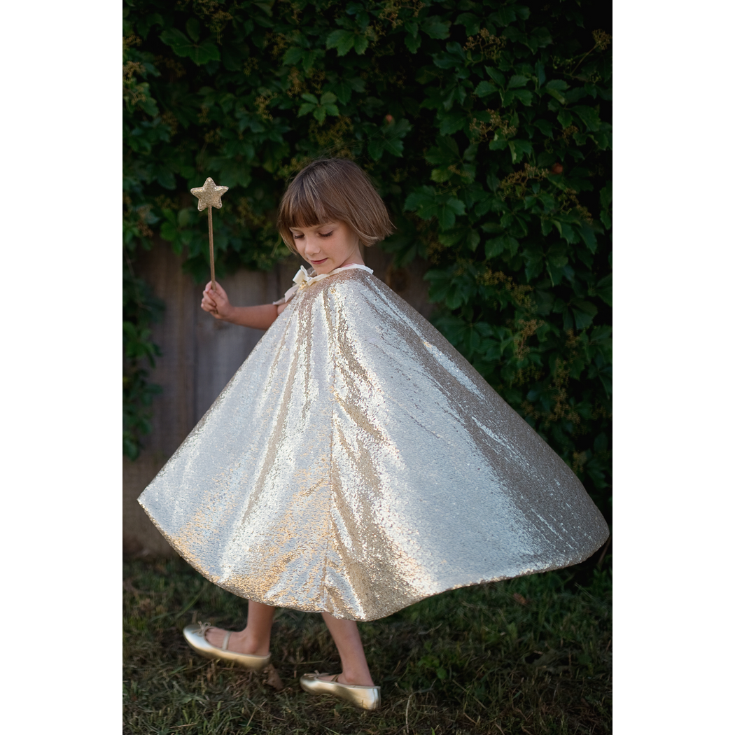 Child twirling in the Gracious Gold Sequin Cape.