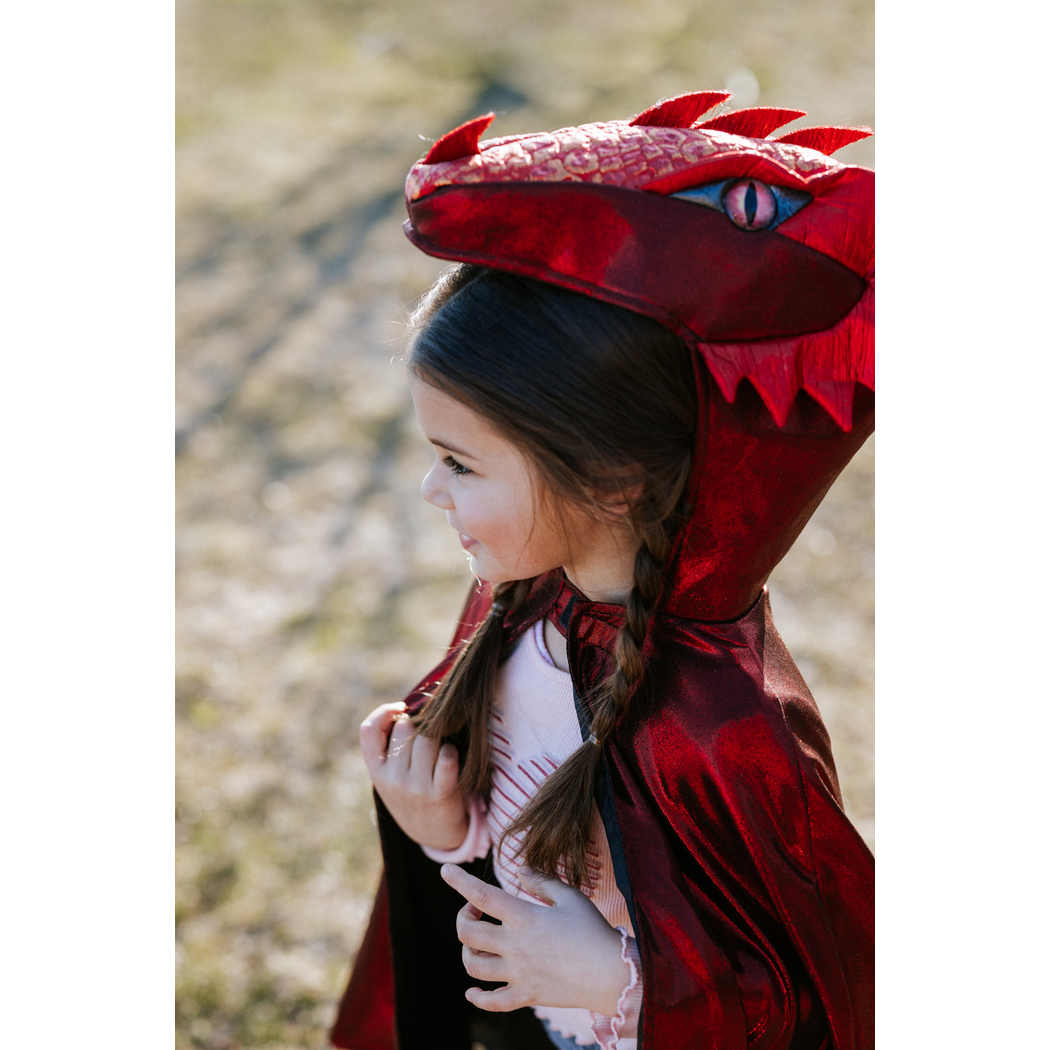 Detail of child wearing the dragon cape with hood on