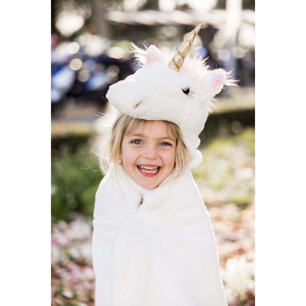 Close up of smiling child with unicorn cape and hood