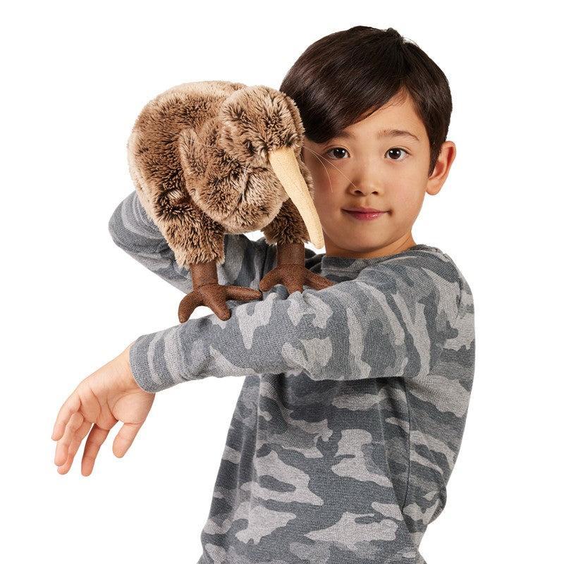 Child wearing a camouflage shirt with a plush toy on their shoulder