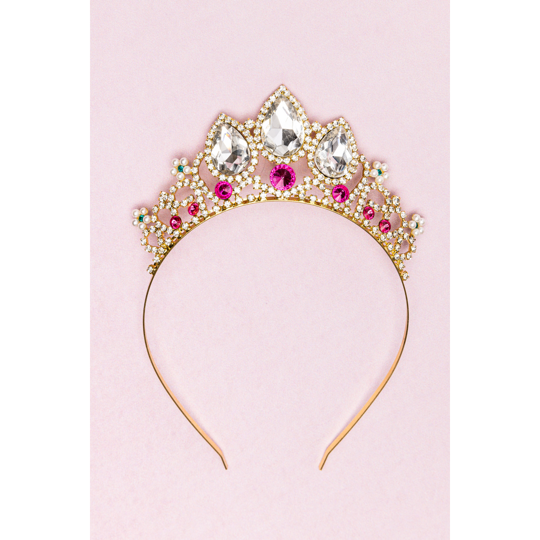 Gold jeweled tiara on pink background