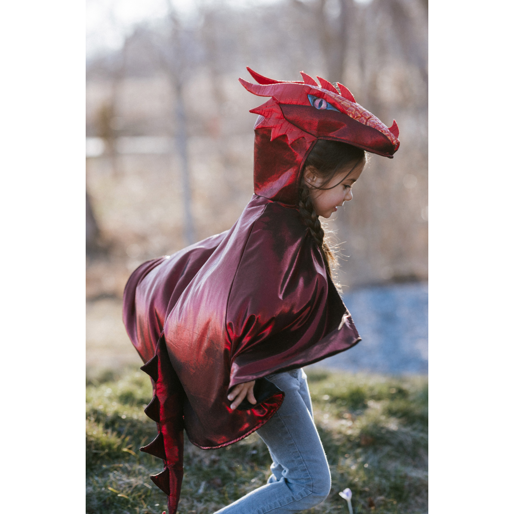 Side view of running child wearing the dragon cape with hood on