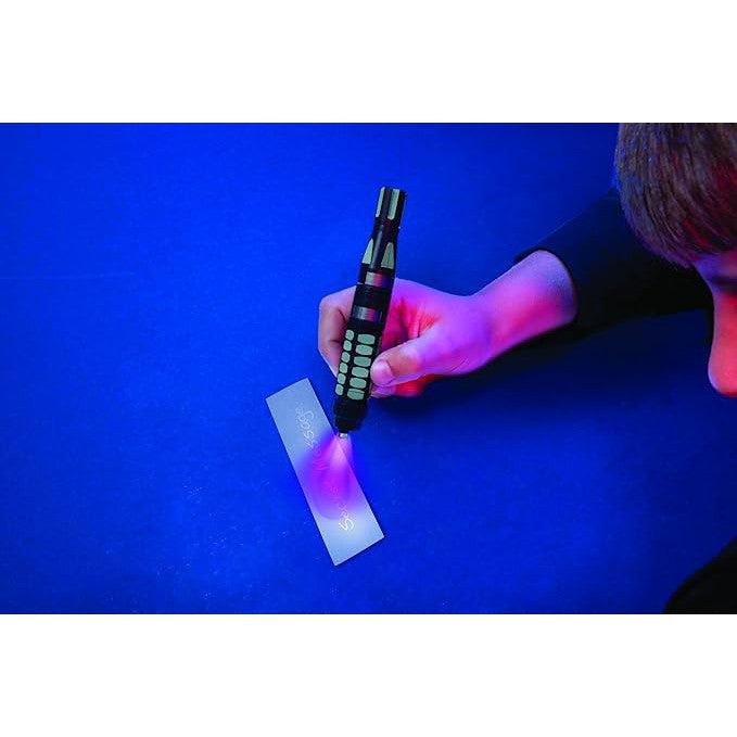 Front view of SpyX Invisible Ink Pen - Write &amp; Read Invisible UV Light Msg a child writing a message on a piece of paper showing the UV light shining on the paper.