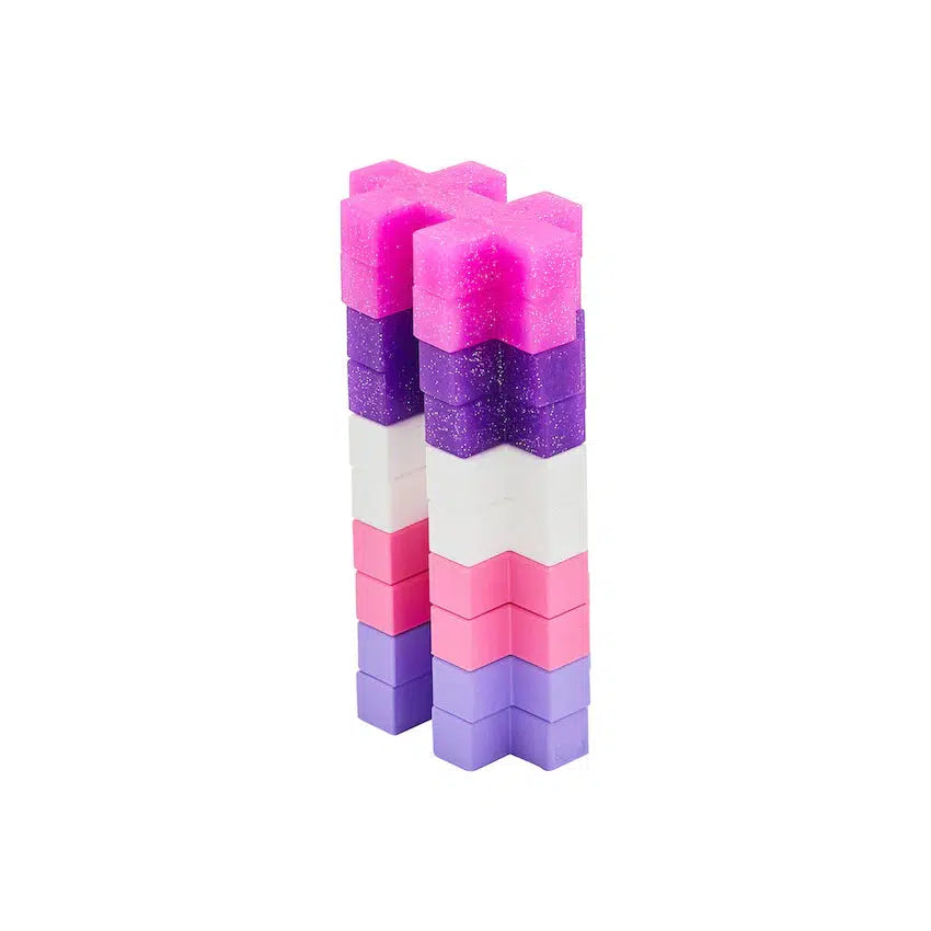 Stack of glitter plus plus in pinks, purples, and white. Each piece is shaped like a puzzle piece with two parallel lines and one perpendicular