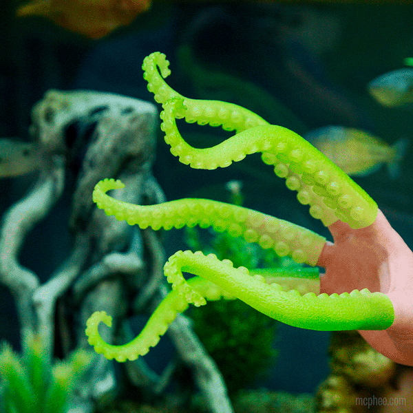 Front right side view of a hand with the Glow Tentacles on it and fades to show them glowing in the dark.
