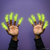 Front view of two arms holding their hands up with glowing in the dark Alien Finger Hands on every finger.