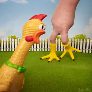 Front view of a chicken looking on as a hand has the Chicken Feet Finger Puppets on two of its fingers.