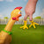 Front view of a chicken looking on as a hand has the Chicken Feet Finger Puppets on two of its fingers.
