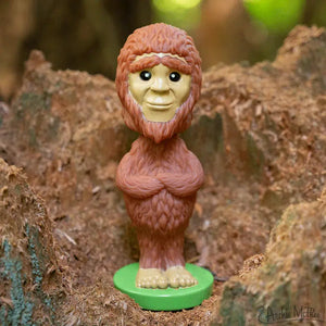 Front view of a Nodder Bigfoot standing on a rock.