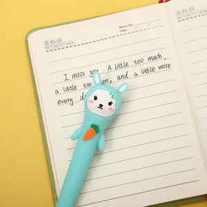 Front view of turquoise bunny laying on top of a journey with writing in it.