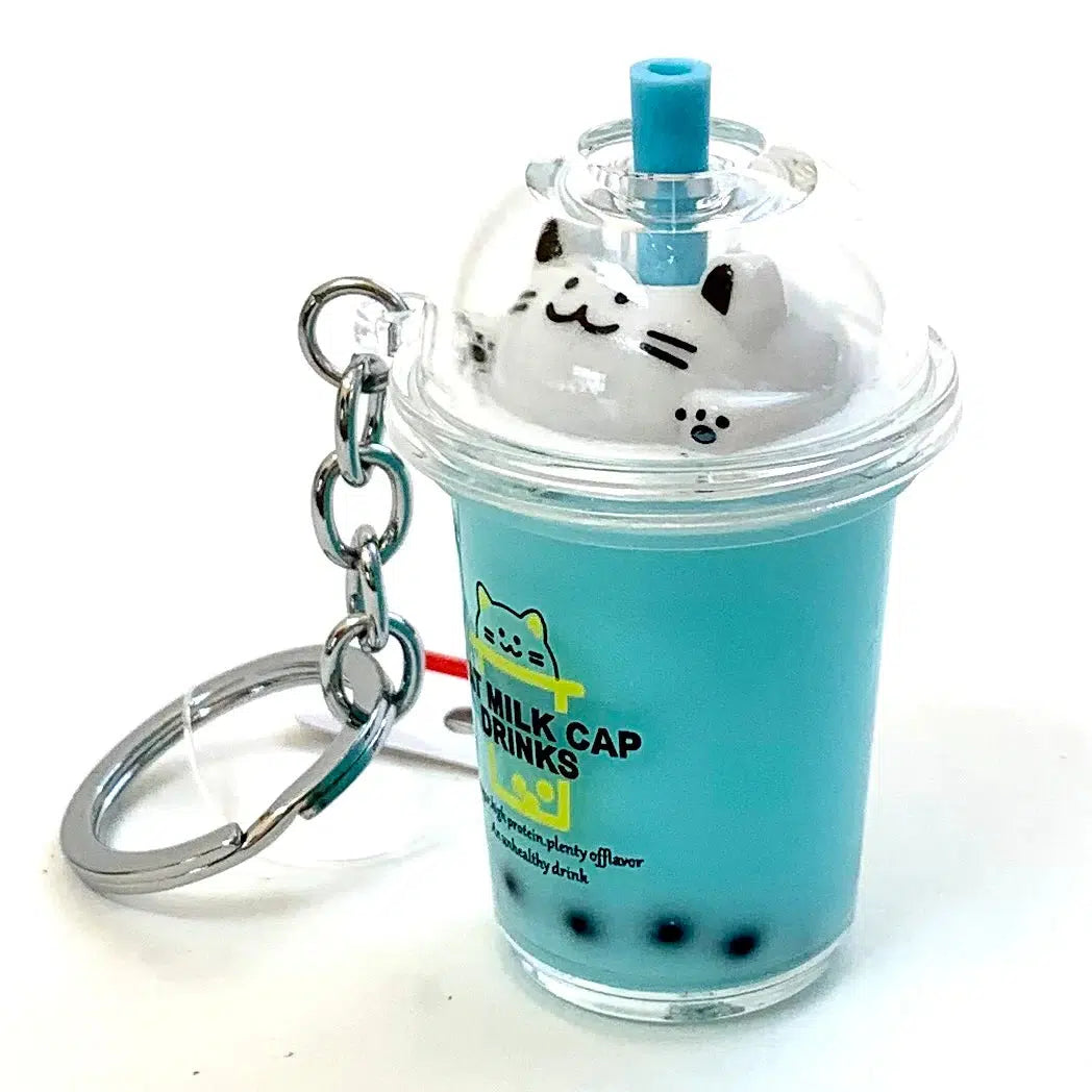Front view of blue liquid with black bobas and cat face on top of cup.