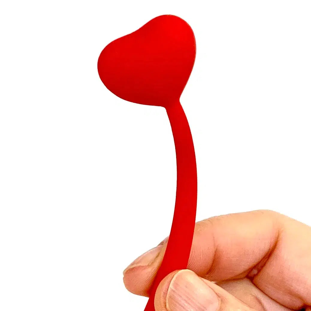 Front view of a person&#39;s hand bending a red Heart Wiggle Gel Pen close to the heart at the top of the pen.