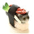 Grey cat sitting on a sushi rice ball with a lobster and on its back with green onions on the side.