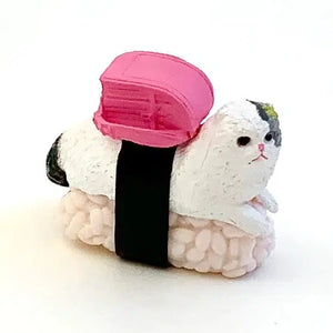 White cat sitting on a sushi rice ball.